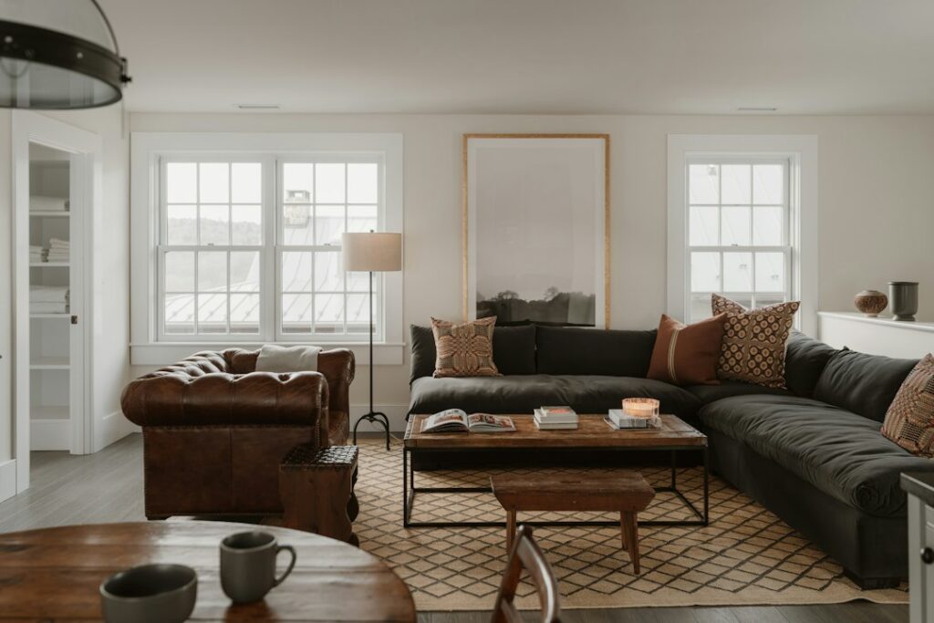A family compares a sofa and L-shaped sectional in a bright living room with measured walking space.